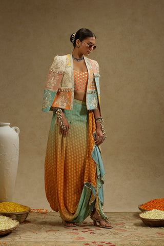 COLOUR BLOCKED PATCHWORK CAPE JACKET PAIRED WITH AN EMBELLISHED BUSTIER AND AN OMBRE PRINTED DRAPED SKIRT